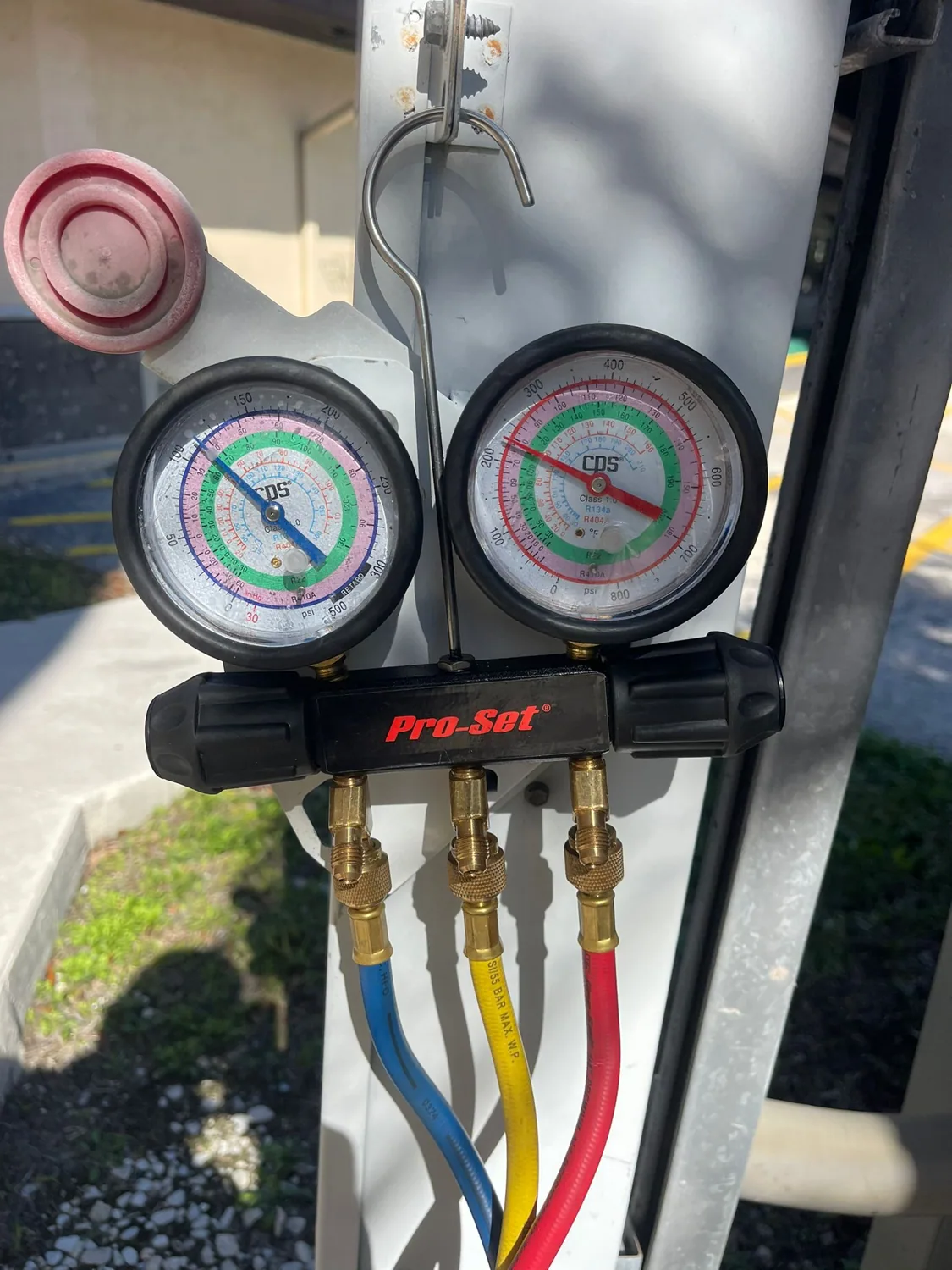 Refrigerant manifold gauges during an AC tune-up