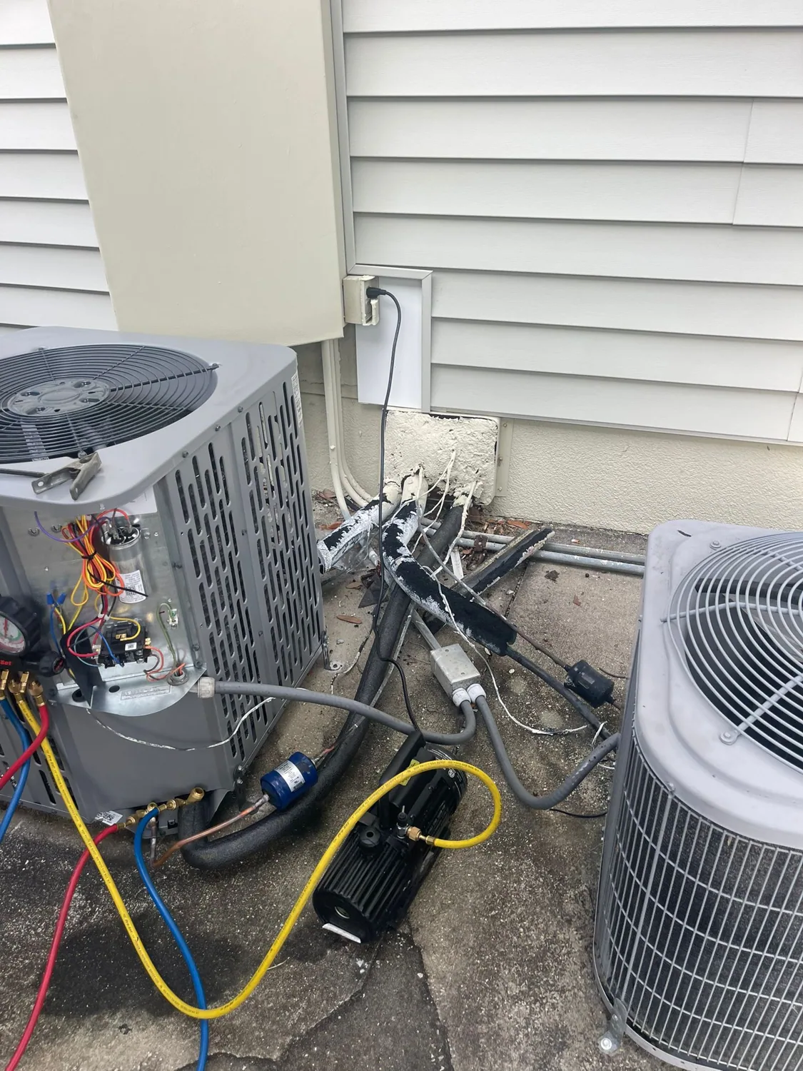 AC condenser units being serviced in Broward County