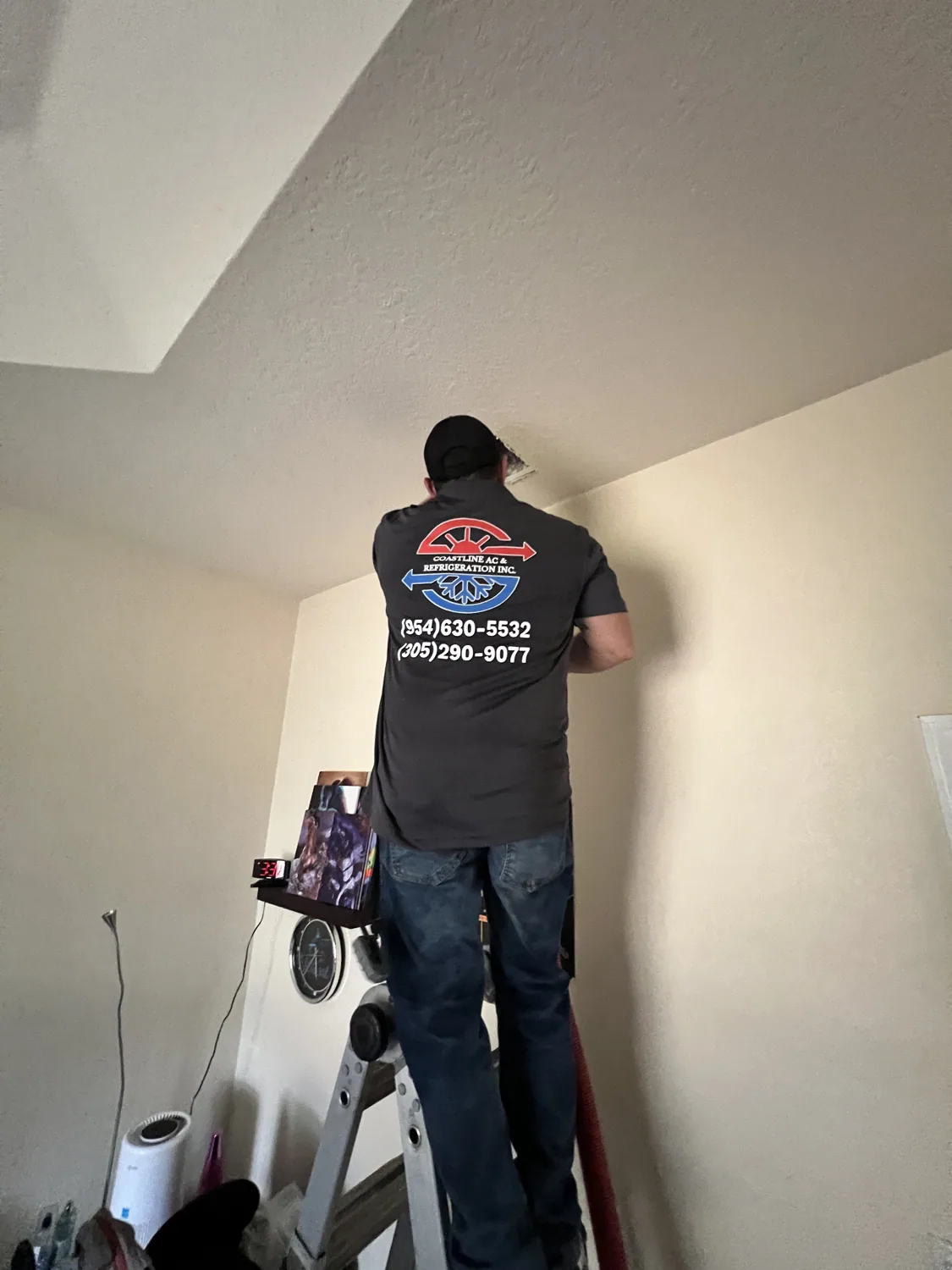 Coastline A/C technician cleaning air ducts in a South Florida home