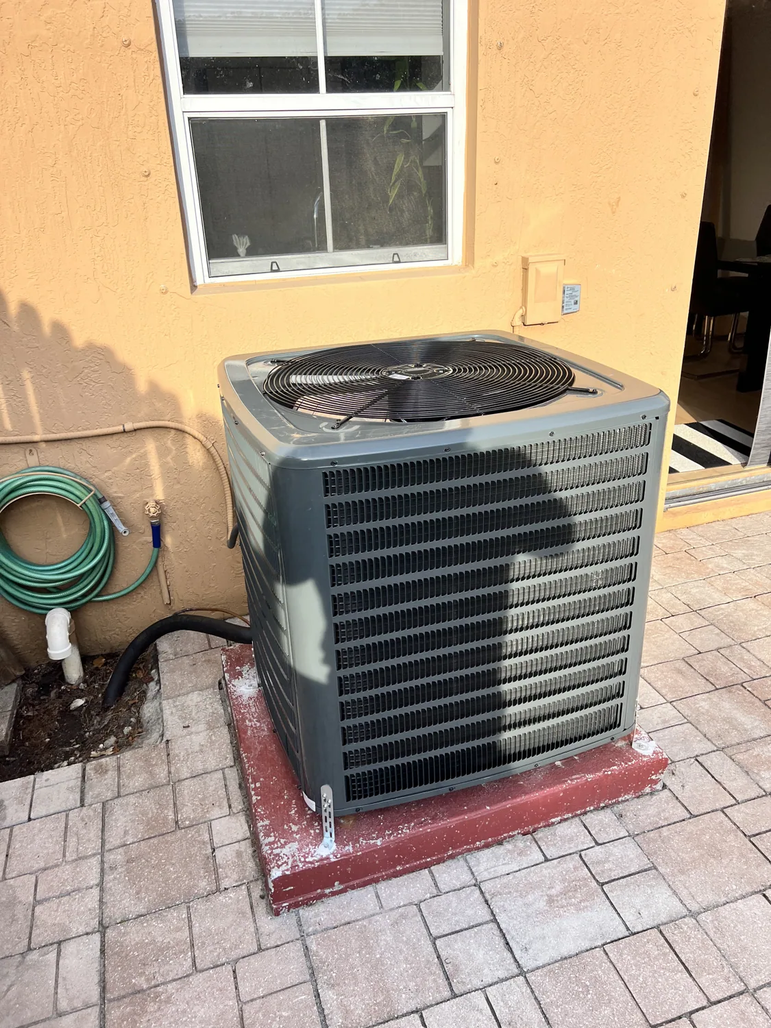 Clean residential AC condenser on a concrete pad
